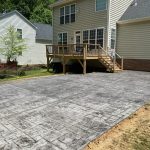 Our Work: A driveway with a deck and a house.