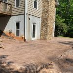 Our Work: A concrete patio in front of a house.