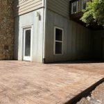Our Work: A wooden deck in front of a house.