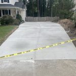 Our Work: A driveway with a yellow tape on it.