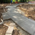 Our Work: Constructing a concrete walkway in a park.