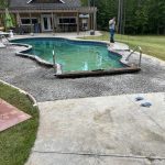 Our Work: A backyard with a pool in the middle of the yard.