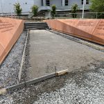 Our Work: A walkway is being built in front of a building as part of our ongoing project.