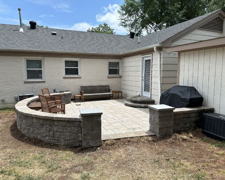 A backyard with a patio and a grill, built by professional Concrete Contractors in Cary, NC.