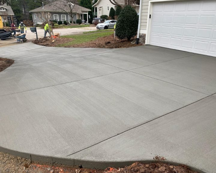 A driveway with a garage door constructed by Concrete Contractors Cary NC.