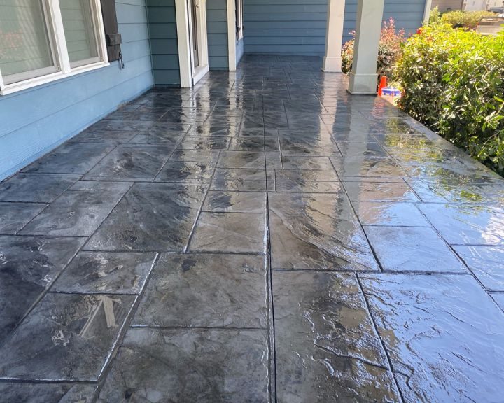 A City-stamped concrete patio with a blue color.